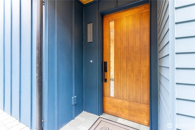 view of exterior entry with elevator and a garage