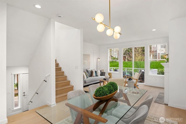 dining room featuring stairway, a notable chandelier, recessed lighting, and light wood-type flooring