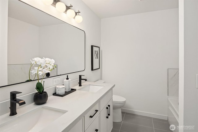 full bath featuring tile patterned flooring, toilet, baseboards, and a sink