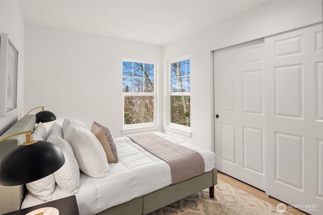 bedroom featuring a closet and light wood-style flooring