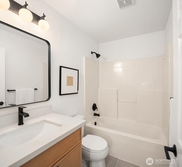 bathroom featuring visible vents, shower / washtub combination, toilet, and vanity