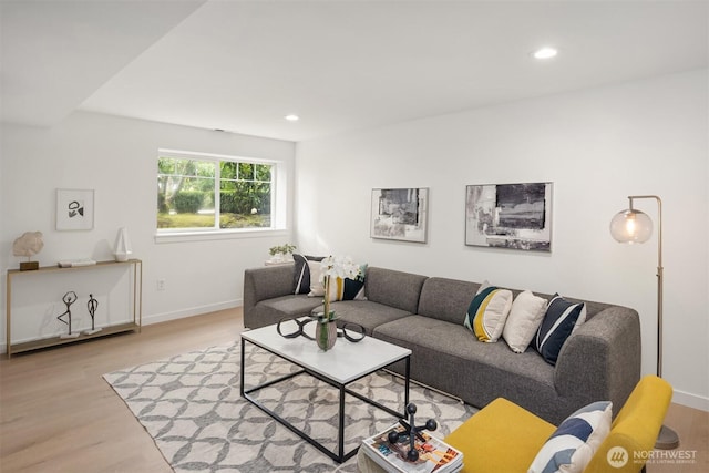 living room with recessed lighting, baseboards, and wood finished floors