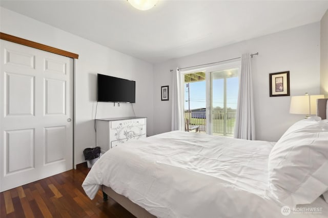 bedroom featuring access to exterior and dark wood-style floors