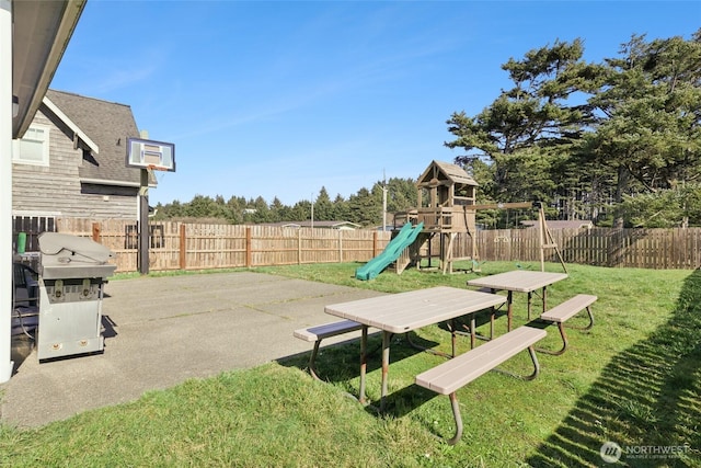 view of yard featuring a patio, a playground, and a fenced backyard