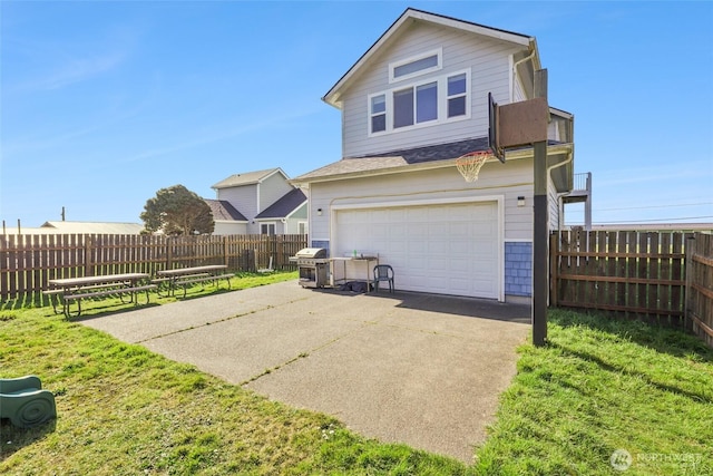 view of side of home with a garage, a yard, driveway, and fence