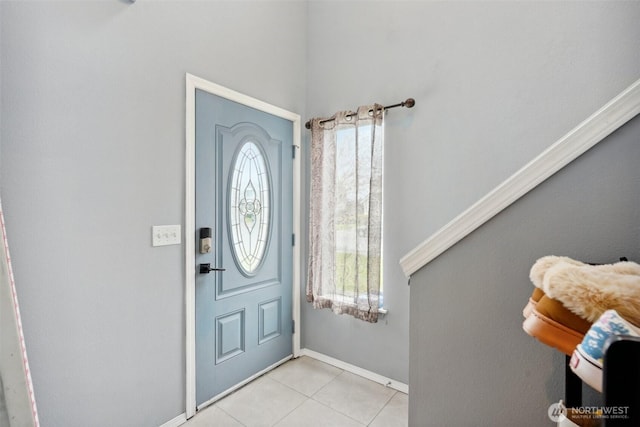 entrance foyer featuring baseboards and light tile patterned flooring