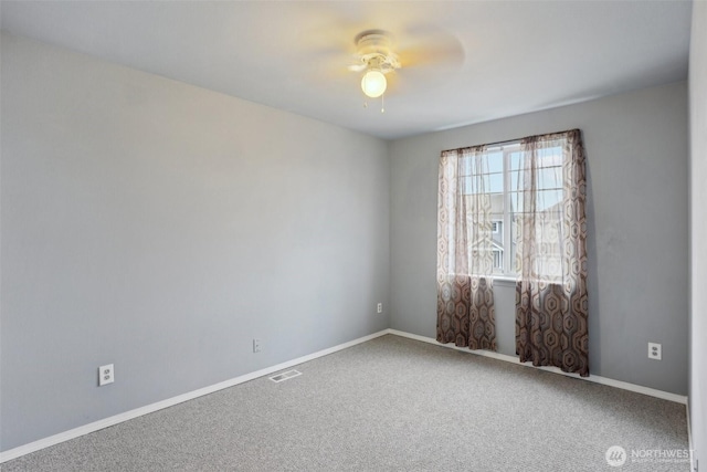 unfurnished room featuring visible vents, baseboards, carpet, and a ceiling fan