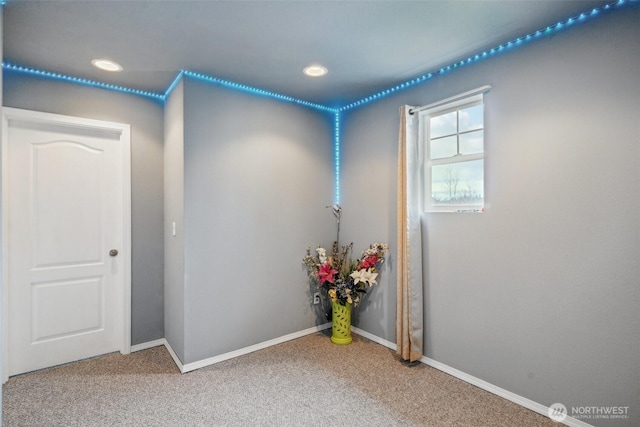 unfurnished room featuring recessed lighting, baseboards, and carpet