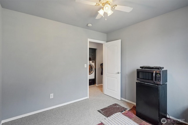 bedroom with baseboards, washer / clothes dryer, ceiling fan, and carpet flooring