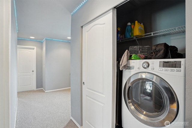 laundry room with baseboards, carpet floors, washer / dryer, and laundry area