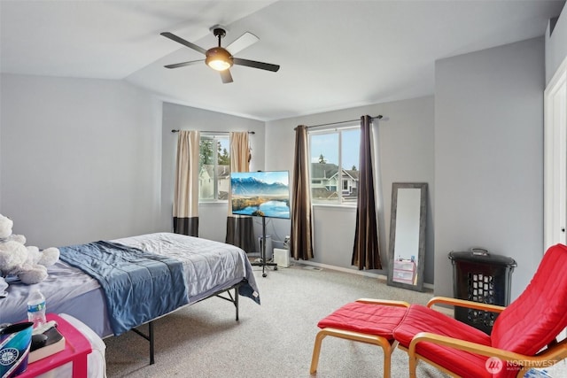 carpeted bedroom featuring lofted ceiling and a ceiling fan