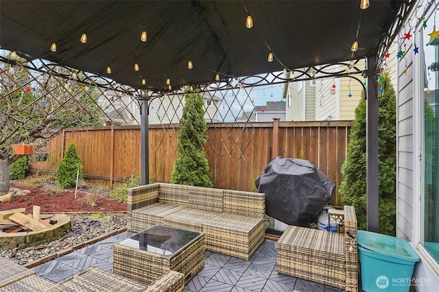 view of patio / terrace with an outdoor living space with a fire pit, area for grilling, and a fenced backyard