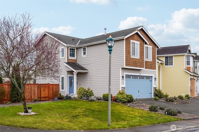 view of front of home with driveway, an attached garage, a front lawn, and fence