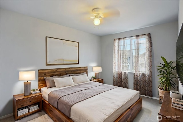 bedroom with a ceiling fan, light colored carpet, and baseboards