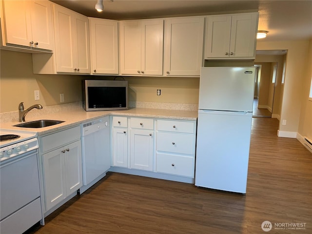 kitchen featuring dark wood finished floors, white appliances, white cabinetry, and a sink