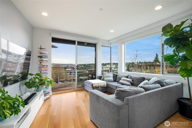 living room with recessed lighting and light wood-style flooring