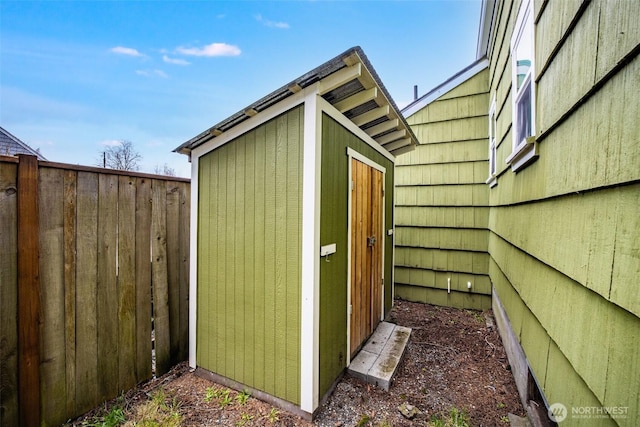 view of shed with fence