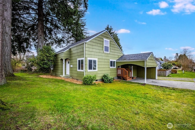 view of front of home with a carport, a front lawn, driveway, and a shingled roof