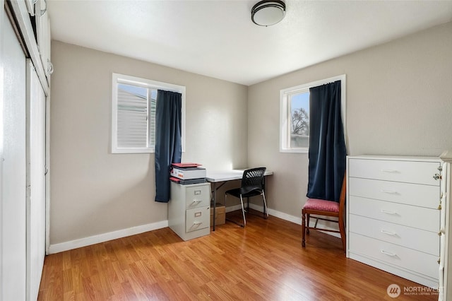 office space with light wood-style flooring and baseboards