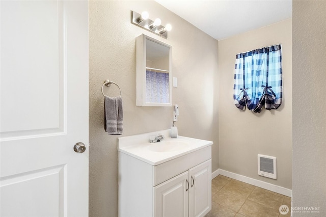 bathroom with tile patterned flooring, visible vents, vanity, and baseboards