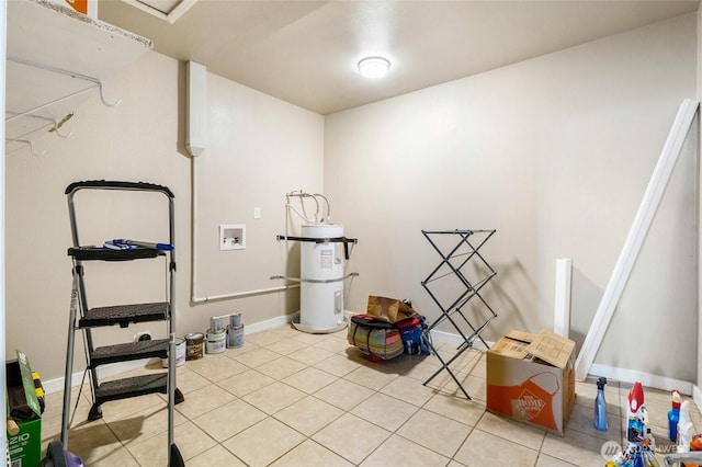 interior space featuring light tile patterned floors, baseboards, washer hookup, and laundry area