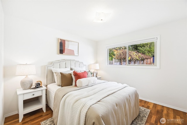 bedroom featuring wood finished floors and baseboards