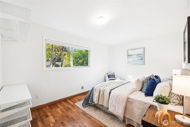 bedroom with wood finished floors and baseboards