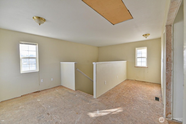 unfurnished room featuring visible vents