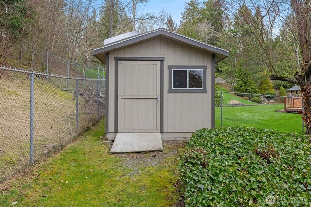 view of shed with fence