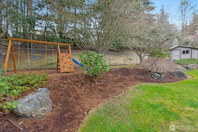 view of yard featuring a storage shed, a playground, an outdoor structure, and fence