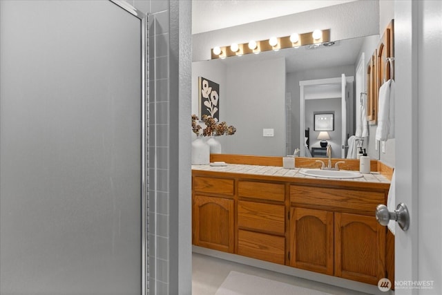 bathroom featuring vanity and a shower with shower door