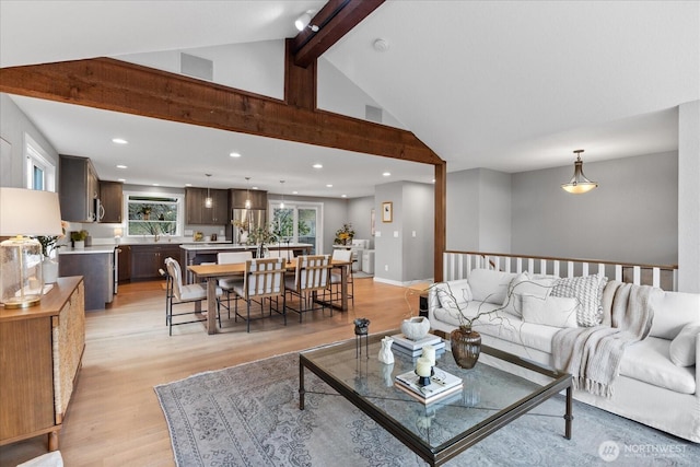 living room with recessed lighting, beamed ceiling, high vaulted ceiling, and light wood finished floors