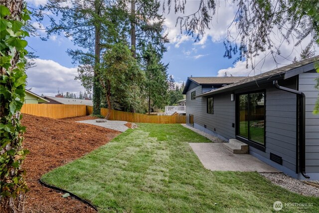 view of yard featuring a fenced backyard and a patio