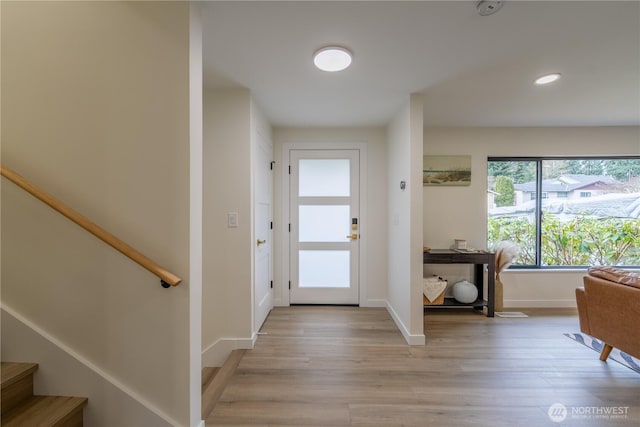 entryway with stairway, recessed lighting, light wood-type flooring, and baseboards