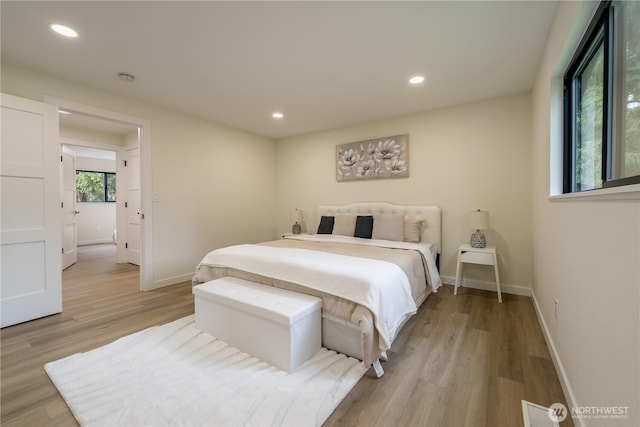 bedroom with visible vents, recessed lighting, light wood-type flooring, and baseboards