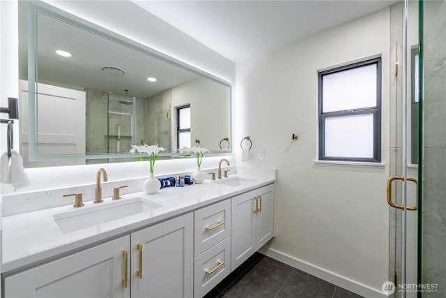 bathroom featuring a sink, plenty of natural light, and a stall shower