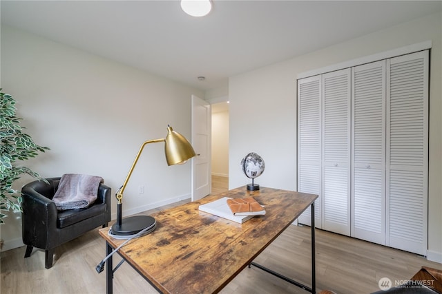 office area featuring baseboards and light wood-style floors