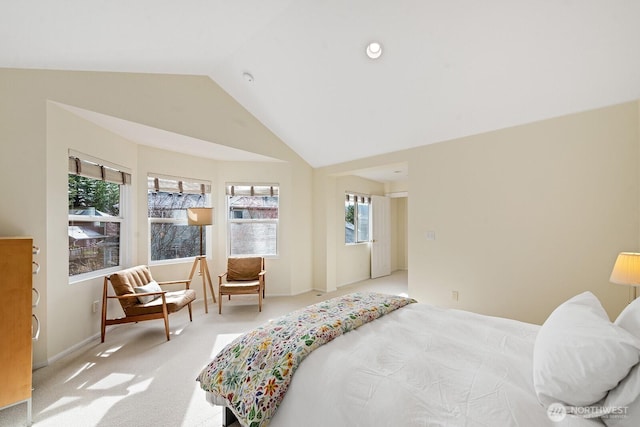 bedroom with vaulted ceiling, baseboards, and carpet floors