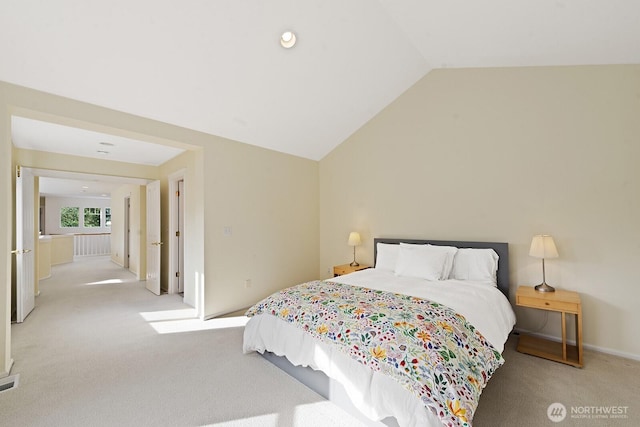 bedroom with carpet flooring and lofted ceiling