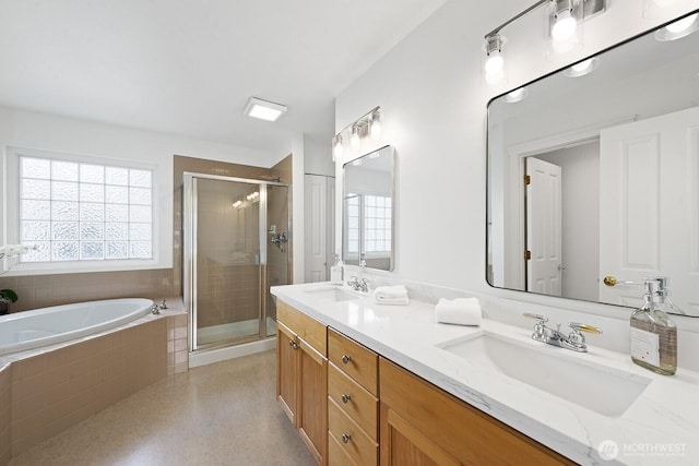 bathroom with a sink, a garden tub, a stall shower, and double vanity