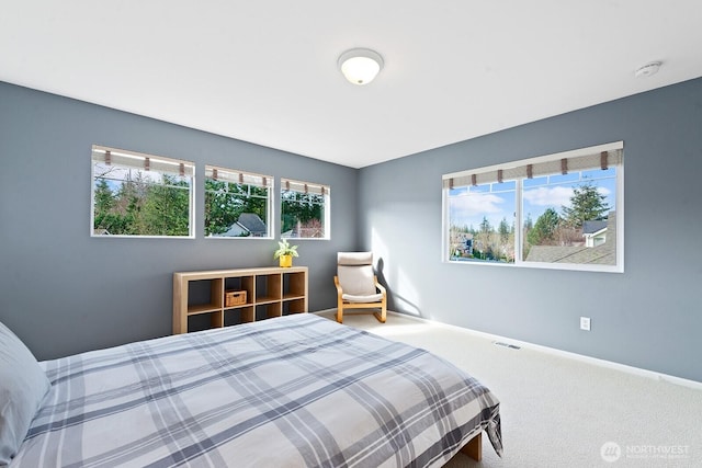 carpeted bedroom with visible vents and baseboards