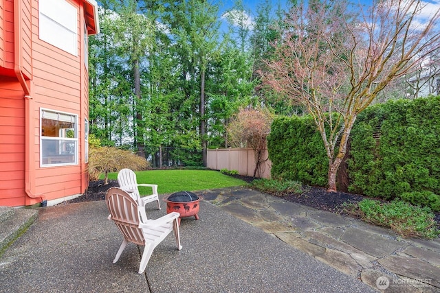 view of patio / terrace with an outdoor fire pit and fence