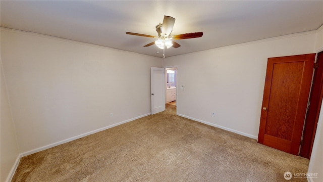 empty room with a ceiling fan, baseboards, carpet floors, and ornamental molding