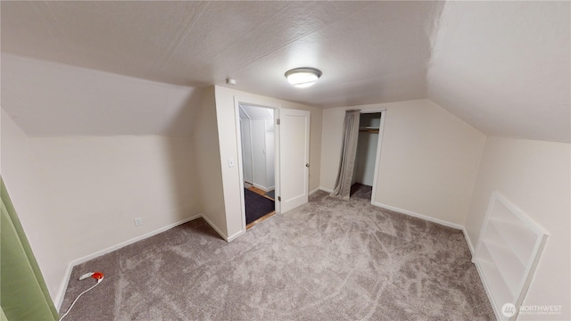 bonus room featuring lofted ceiling, baseboards, and carpet floors