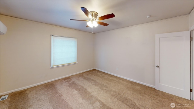 empty room with visible vents, ceiling fan, carpet flooring, and crown molding