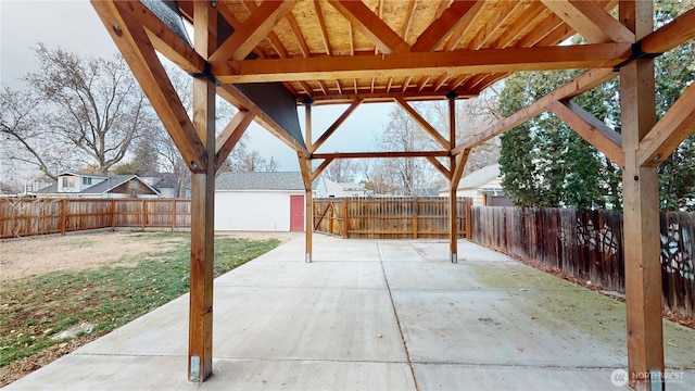 view of patio / terrace with an outbuilding and a fenced backyard