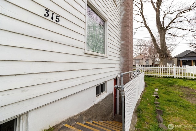 view of property exterior featuring fence and a chimney