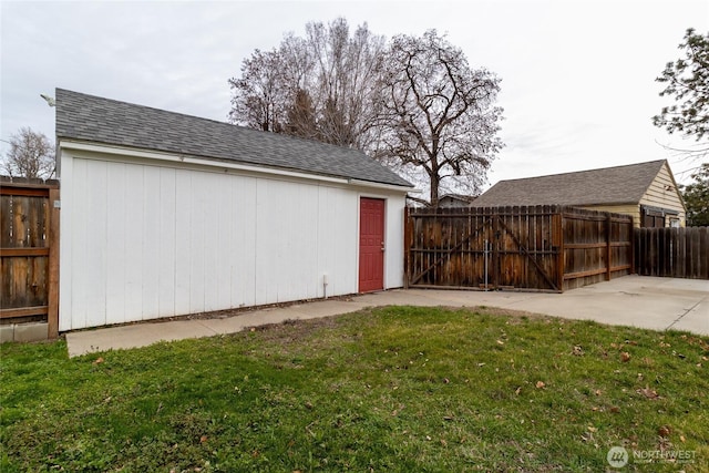 view of yard with an outbuilding, fence, and a patio area