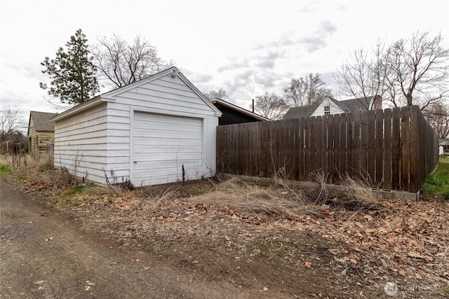 detached garage featuring fence