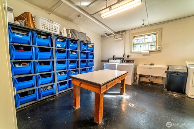 interior space with a sink, concrete flooring, and washing machine and clothes dryer